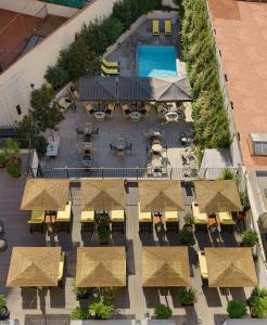 an aerial view of a courtyard with umbrellas and a pool at H10 Metropolitan 4* Sup in Barcelona