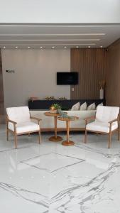 a living room with a couch and a table and chairs at Hotel Pé de Serra in Nossa Senhora da Glória +4 photos