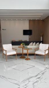 - un salon avec un canapé, une table et des chaises dans l'établissement Hotel Pé de Serra, à Nossa Senhora da Glória