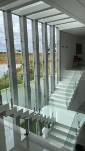 a glass stair case in a building with columns at Hotel Pé de Serra in Nossa Senhora da Glória