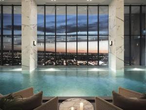 a large swimming pool with a view of a city at Premium hotel apartment Aeon towers Sheikh Zayed City in 6th Of October