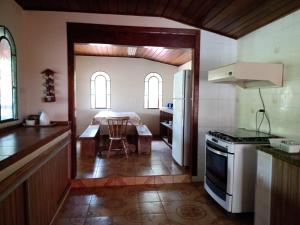 a kitchen with a table and a kitchen with a stove at casa donna zilda in Extrema