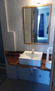 a bathroom with a white sink and a mirror at Hostal Yaku Montañita in Montañita