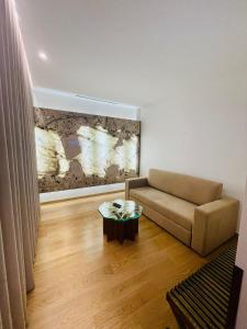 a living room with a couch and a table at Castelo Hotel in Chaves