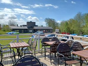 a row of tables and chairs on a patio at Vandrarhem & Lofthus Solstickan Mellbystrand in Mellbystrand