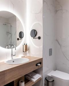 a bathroom with a sink and a toilet at Hotel Alkmaar in Alkmaar