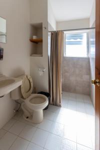 a bathroom with a toilet and a sink and a shower at Villas Huitepec in San Cristóbal de Las Casas