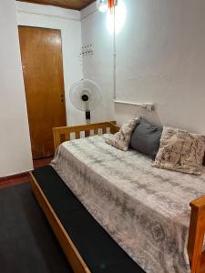 a bedroom with a large bed with a fan at Monoambiente F en Ctes Cap in Corrientes