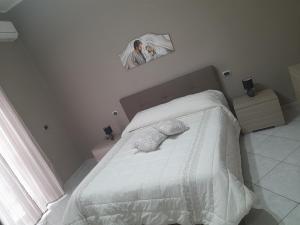 ein Schlafzimmer mit einem Bett mit einem Bild an der Wand in der Unterkunft Casa Brezza marina in Barletta