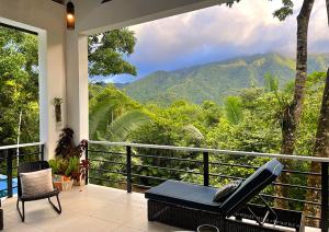 a balcony with a view of a mountain at Aracari Lodge & Jungalows in Middlesex
