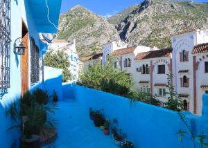 a view of a town with blue walls and mountains at CASA BLUE PEARL in Chefchaouen