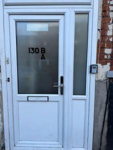 a white door with a sign on it at Willesden Guest Room 130 in London