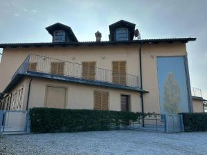 a building with a balcony on top of it at Cascina Boschetti in Barolo