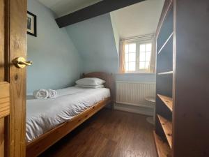 a small bedroom with a bed and a window at Cherry Garth in Sleights