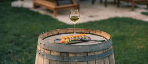 a glass of wine and sushi on a barrel at Aza Cave Cappadocia Adult Hotel in Göreme