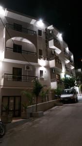 a car parked in front of a building at night at Amaryllis Hotel in Karpathos