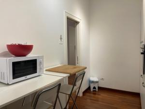 a kitchen with a counter with a bowl on top of a microwave at Berga Exclusive Suite in Bari