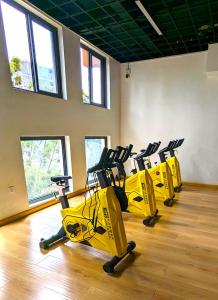 a row of yellow exercise bikes in a gym at Urban Haven 3BR Apartment in Nairobi
