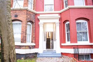 a red brick house with a white front door at Chill Nexus Oasis in Liverpool