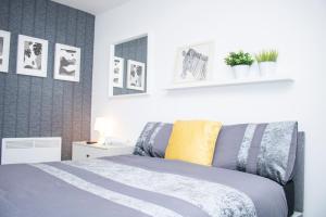 a bedroom with a bed and some pictures on the wall at Chill Nexus Oasis in Liverpool