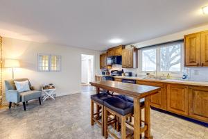 a kitchen with wooden cabinets and a table at Falling Leaf Hideaway in Canandaigua