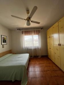 a bedroom with a bed and a ceiling fan at orlando in Porto Garibaldi