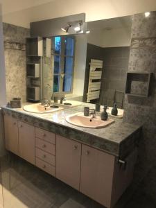 a bathroom with two sinks and a large mirror at Villa Evalou de 240 m². in Trévignin +48 photos