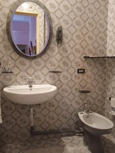 a bathroom with a sink and a mirror at La Casa dei sapori 8 letti 3 came 1 cucina in Mirandola