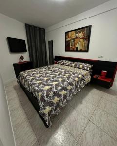 a bedroom with a bed with a comforter on it at Apartment for 4 person! Viña del mar in Playa de las Americas