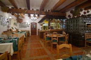 a restaurant with tables and chairs in a room at Hotel U Pekaře - Jítravský Dvorec in Rynoltice