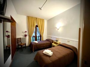 Posteľ alebo postele v izbe v ubytovaní Hotel Pinguino