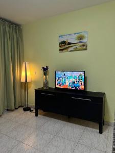 a living room with a flat screen tv on a cabinet at Apartment for 4 person! Viña del mar in Playa de las Americas