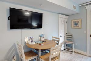 a dining room with a table and a television on the wall at Lasata 3204 in Destin