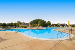 a large swimming pool with blue water at Bethany Bay --- 1004 Pavilion Dr in Ocean View