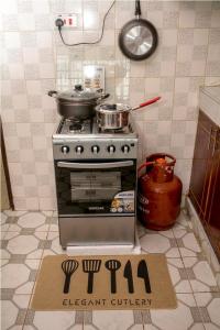 a kitchen with a stove and a sign on the floor at Elegant 2 Bedroom Apartment close to Rupa Mall, Noble Hotel,Poa PLace, Mediheal hospital, TopHill Hospital and St Lukes Hospital in Eldoret