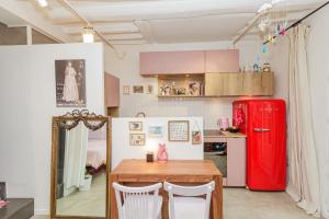 a kitchen with a table and a red refrigerator at Great And Sublime Studio Near The Sacred Heart in Paris