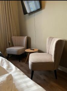 a hotel room with two chairs and a table at Steel Hotel in Smedjebacken