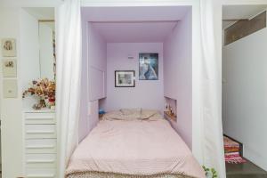 a bed in a room with purple walls at Great And Sublime Studio Near The Sacred Heart in Paris