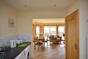 a kitchen and dining room with a view of a living room at Beachcombers in Pollachar