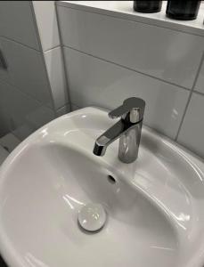 a white bathroom sink with a faucet on it at Steel Hotel in Smedjebacken