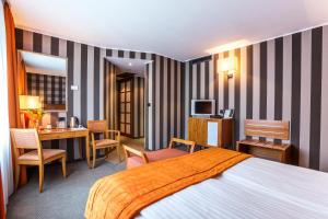 A bed or beds in a room at Eurostars Sofia City
