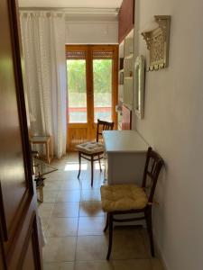 a kitchen with a table and chairs in a room at AL MANDORLO Casa Vacanze in Viterbo