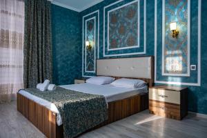 a bedroom with a bed and blue walls at Qafqaz Panoramic Mountain Chalet in Gabala