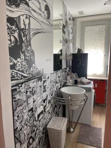 a bathroom with a white sink and a wall at Bon Bon del Centro no Ztl a due passi da Piazza Alfieri in Asti