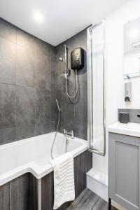 a bathroom with a shower and a tub and a sink at Dovedale Manor 8 Bedrooms in Tissington +24 photos