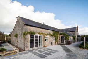 an old stone building with a courtyard at Dovedale Manor 8 Bedrooms in Tissington
