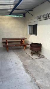 two benches sitting next to a building with a window at Casita de Piedra 11 in Trinidad