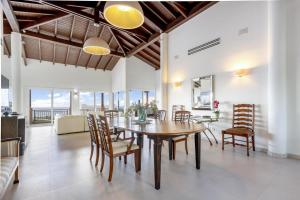 a dining room with a table and chairs at Fine 3 BR Oceanview Penthouse in Prime Location - La Perla Sky in Cupecoy