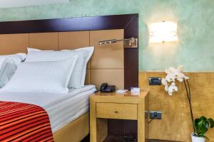 A bed or beds in a room at Eurostars Sofia City