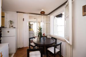 a small kitchen and dining room with a table and chairs at Apartment Kinkela in Dubrovnik
